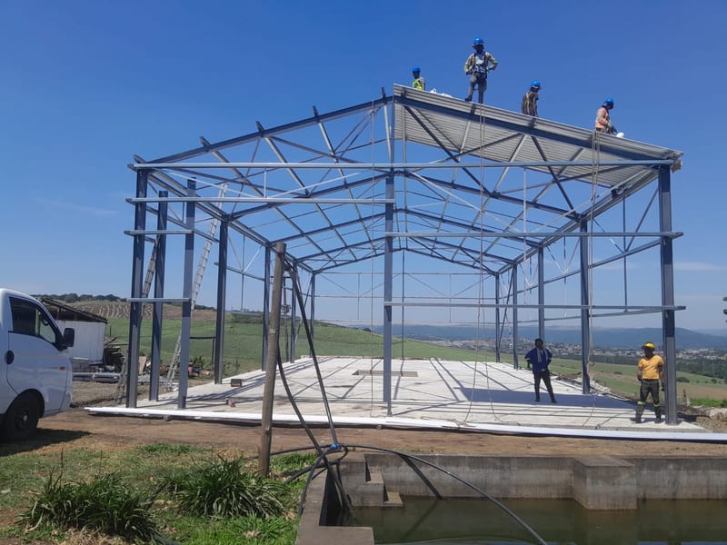 CSI prefab steel structure being erected with roof sheeting